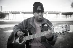 Homeless woman with guitar 700p BW